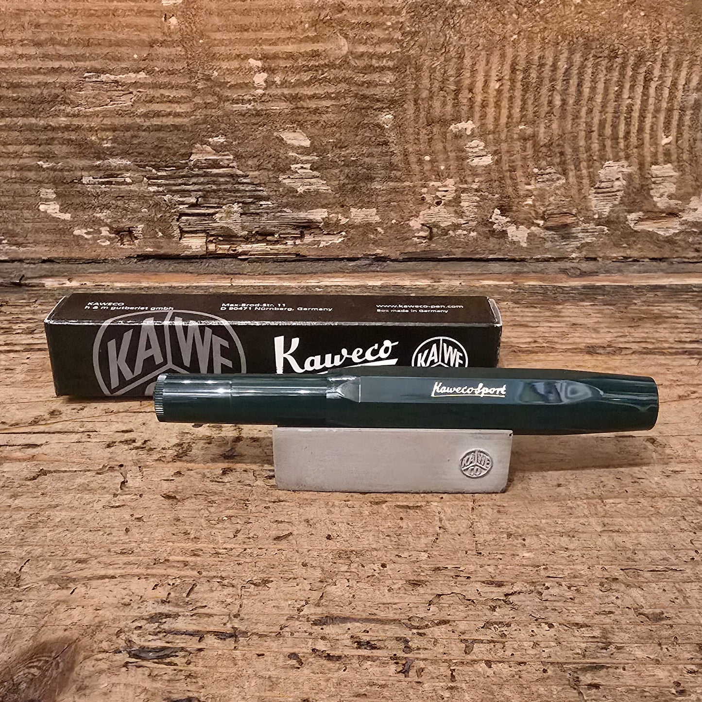 Dark Green Kaweco Pen on wooden block with black behind on a wooden background