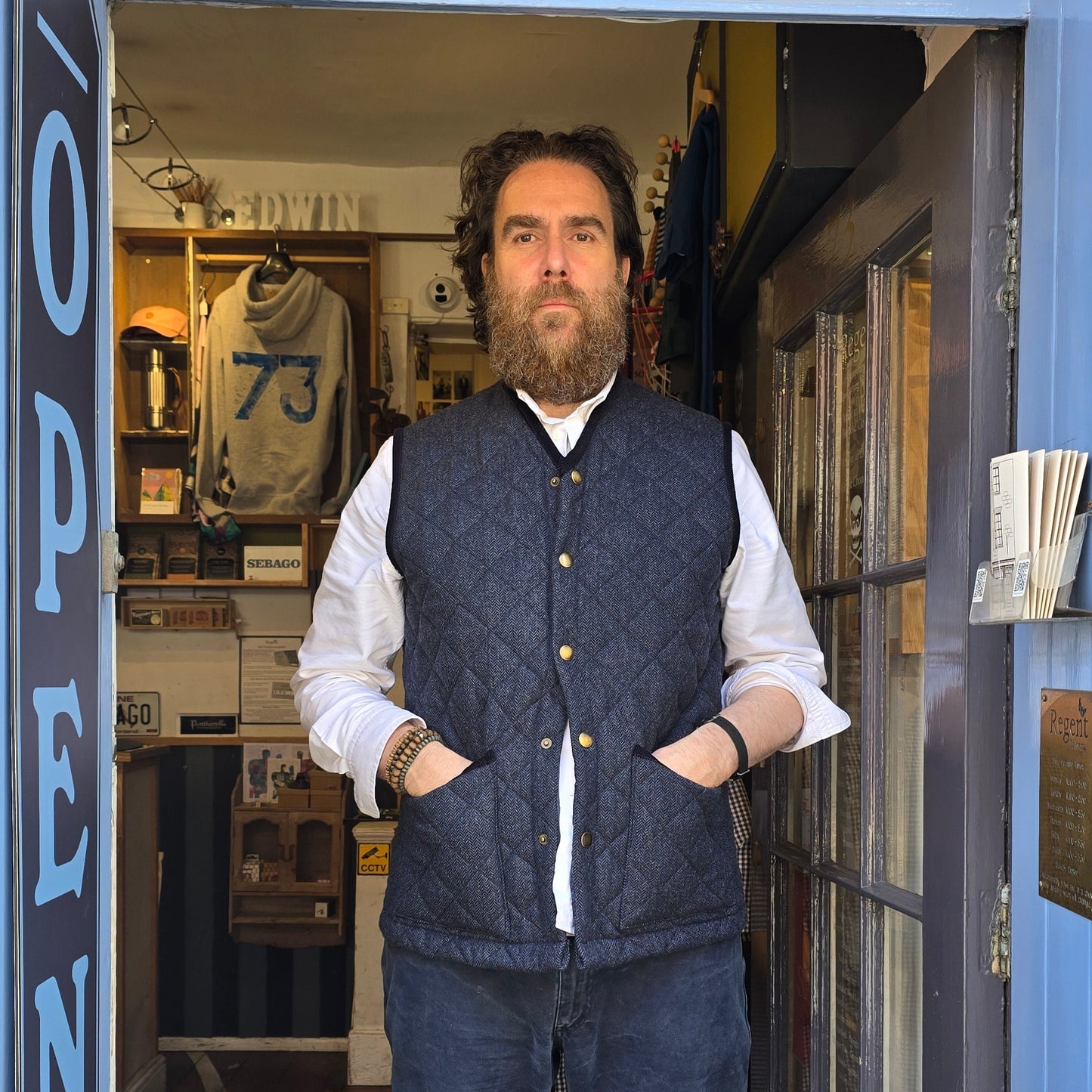 Man standing in front of a store with colorful glass door