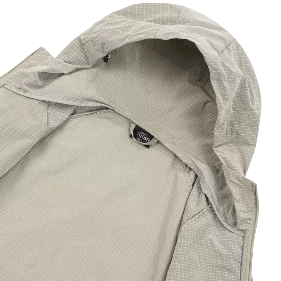 Close-up of a hooded jacket in a light gray and white micro-check pattern, showing the interior hood lining and a small black brand tag that reads ALOHA.