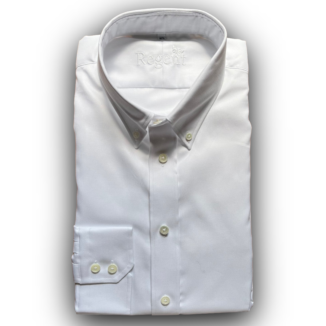 Folded white dress shirt with collar and buttons on a light gray background