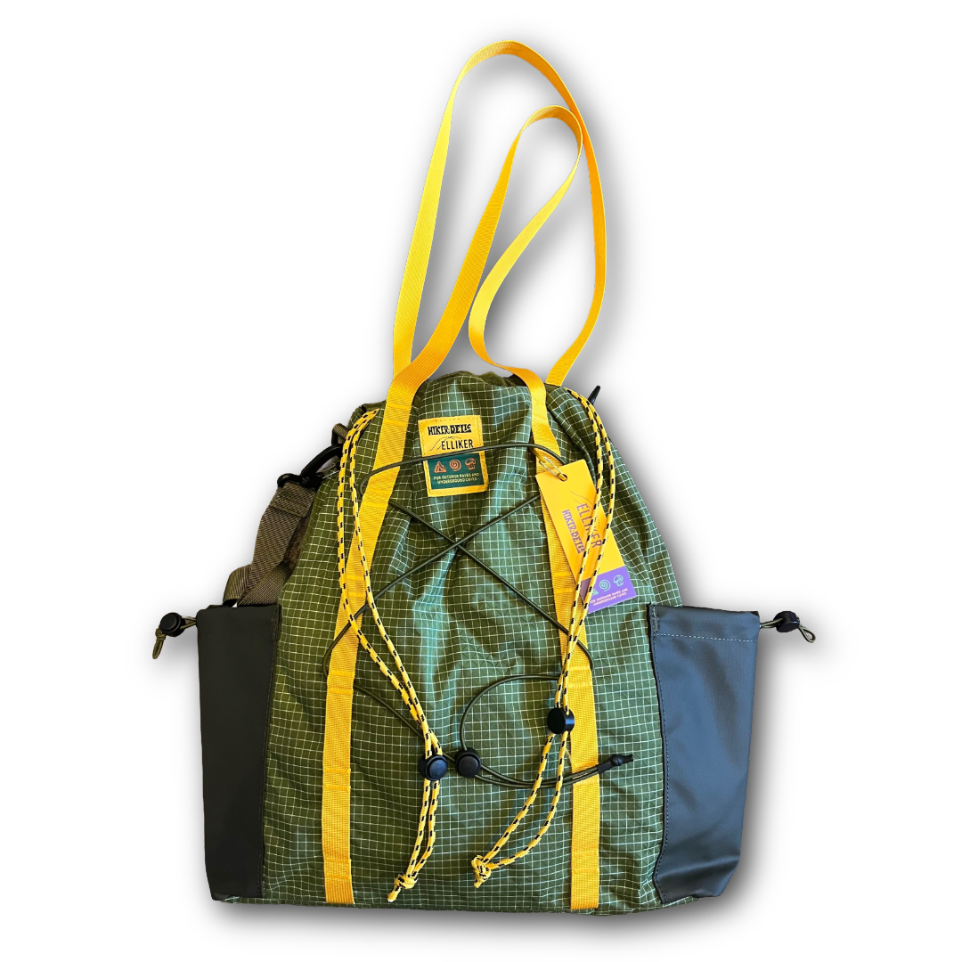 Green plaid backpack with yellow straps on a white background tote bag/ backpack sold at regent in salisbury