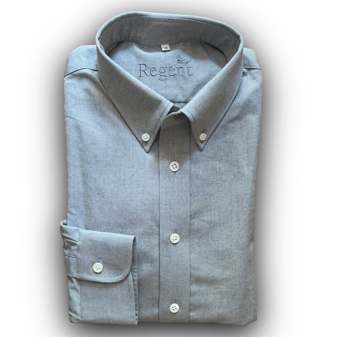 Folded light grey shirt with 'Regent' branding on a white background