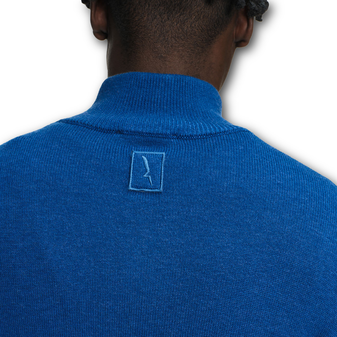 Blue Aigle sweater with a logo on the back against a white background sold at Regent in Salisbury