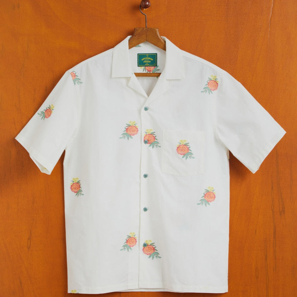 White Cuban collar shirt with short sleeves and white shirt with scattered red,yellow green floral designs 