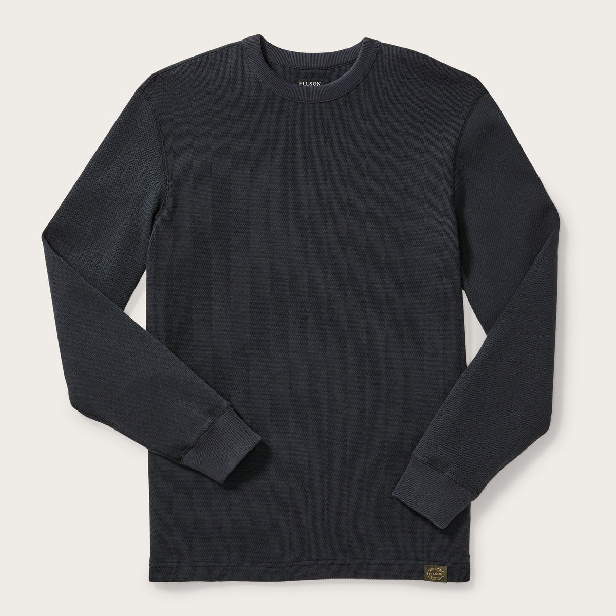 Black long-sleeve shirt on a light gray background