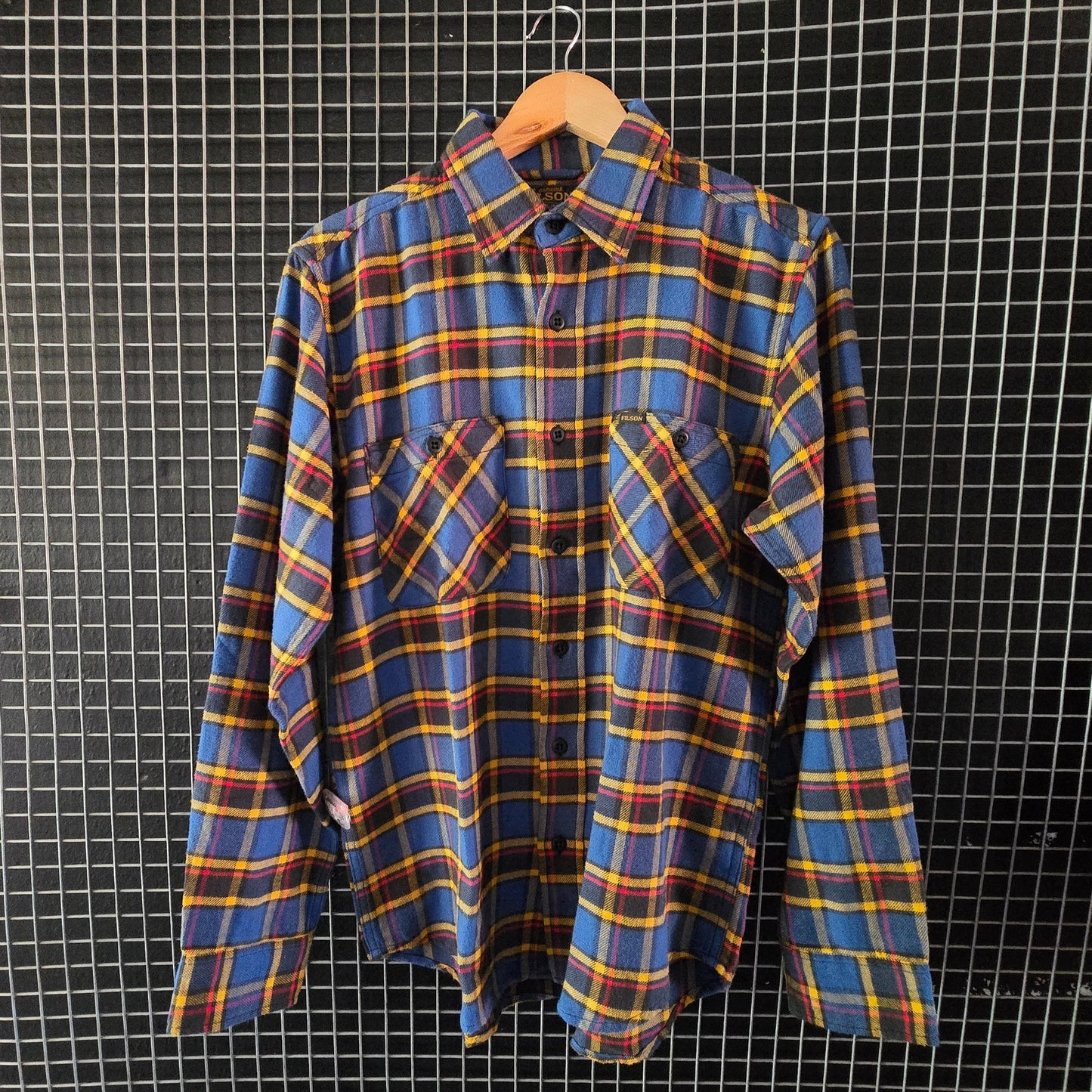 Plaid shirt hanging on a grid wall