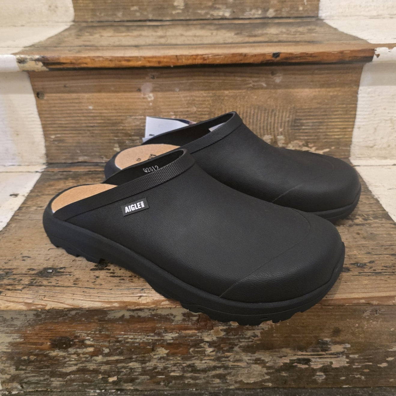 Black clogs on a wooden step