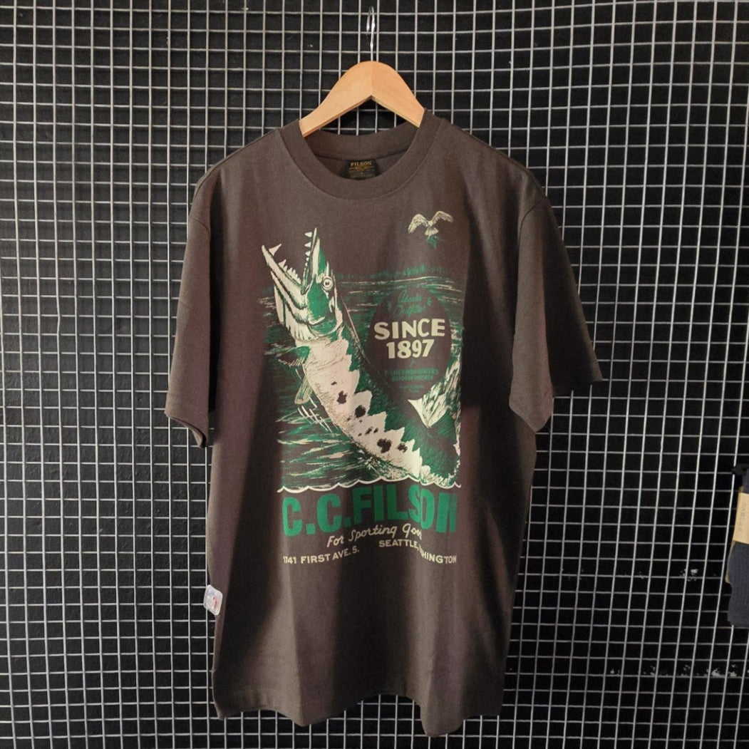 Charcoal t-shirt with graphic design on a hanger against a grid wall
