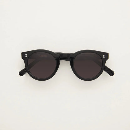 thick rimmed black sunglasses, with round lenses and silver detail in corner.