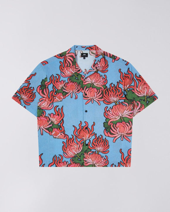 Blue patterend shirt with red,pink and green floral pattern. Cuban collar and short sleeve design.