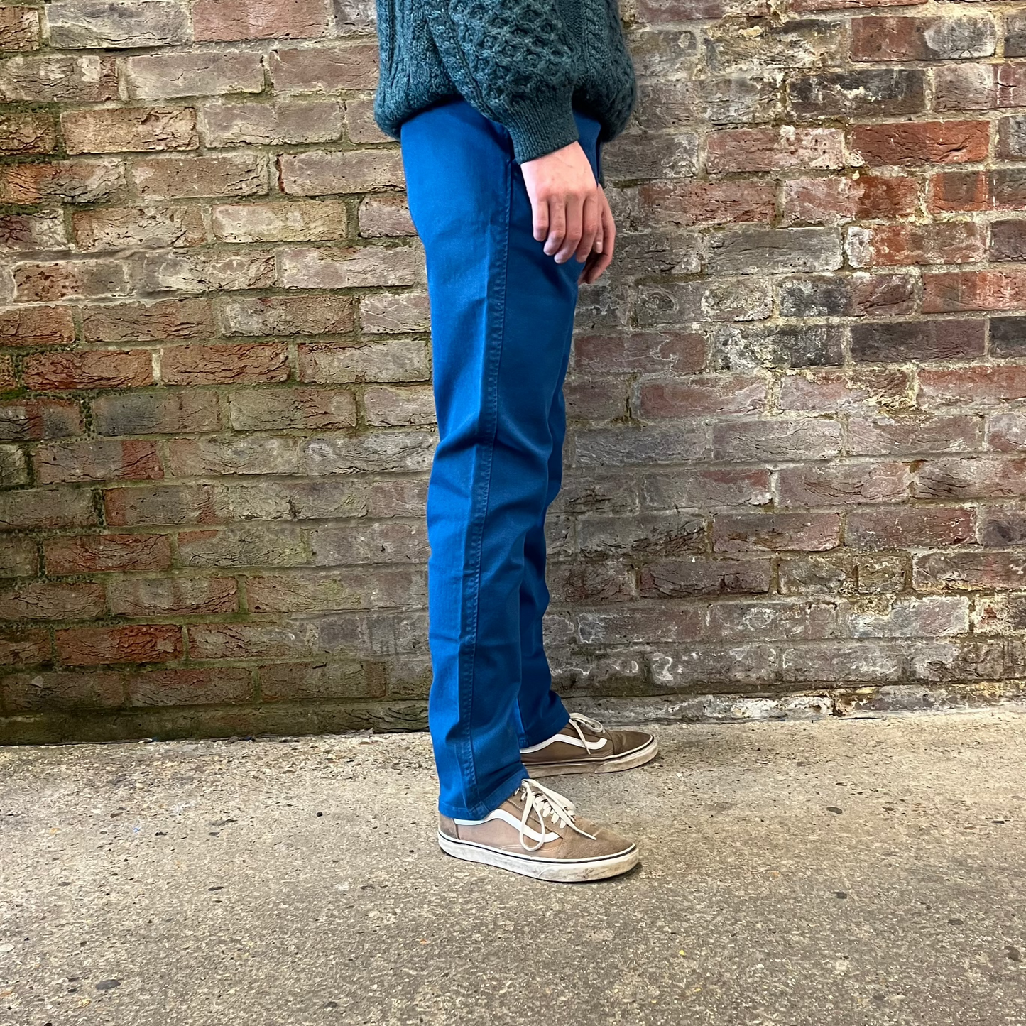 A person wearing blue chinos