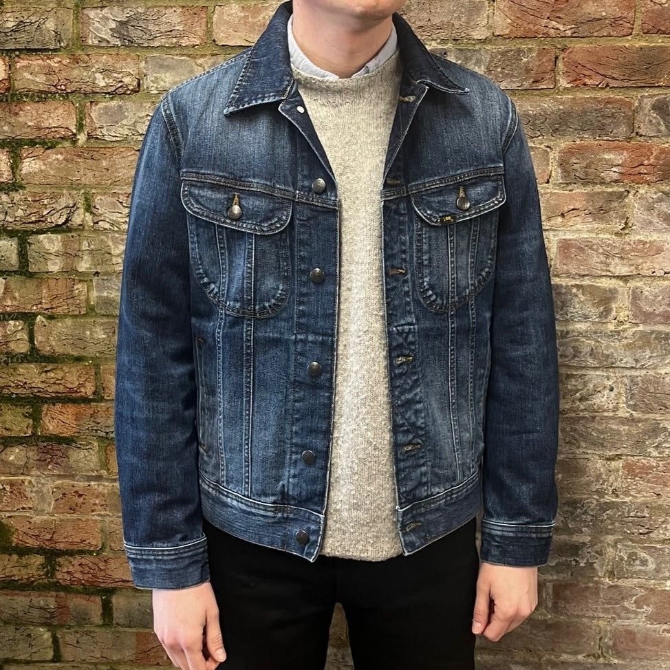 Mid Dark wash denim jacket two front button up flap pockets.