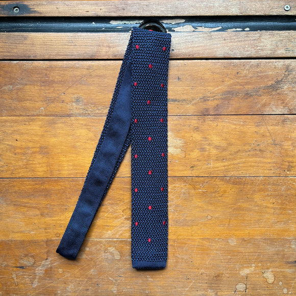 Regent silk knitted tie in navy with red spot pattern