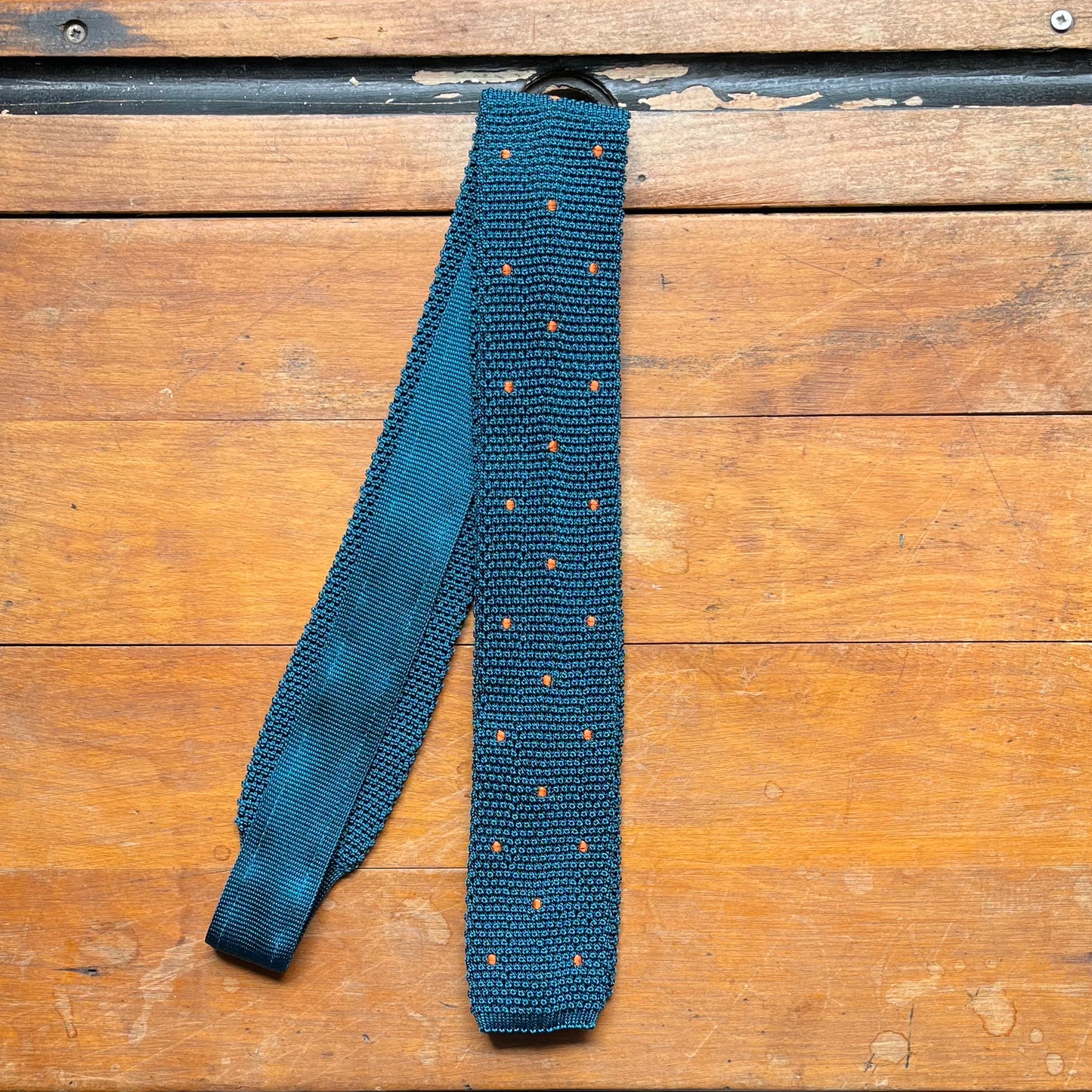 Regent silk knitted tie in teal with orange spots