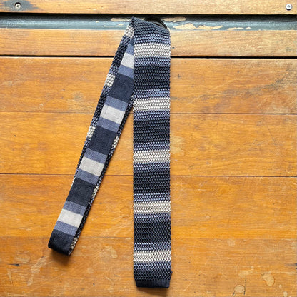 Regent knitted silk tie in alternating stripes of slate grey and champagne, and navy blue