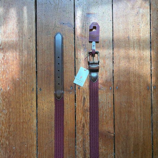 Burgundy belt on wooden floor
