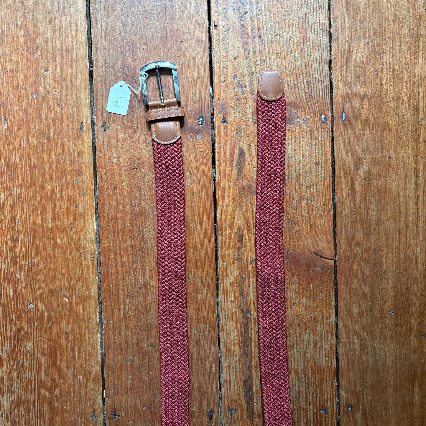 Burgundy belt on wood