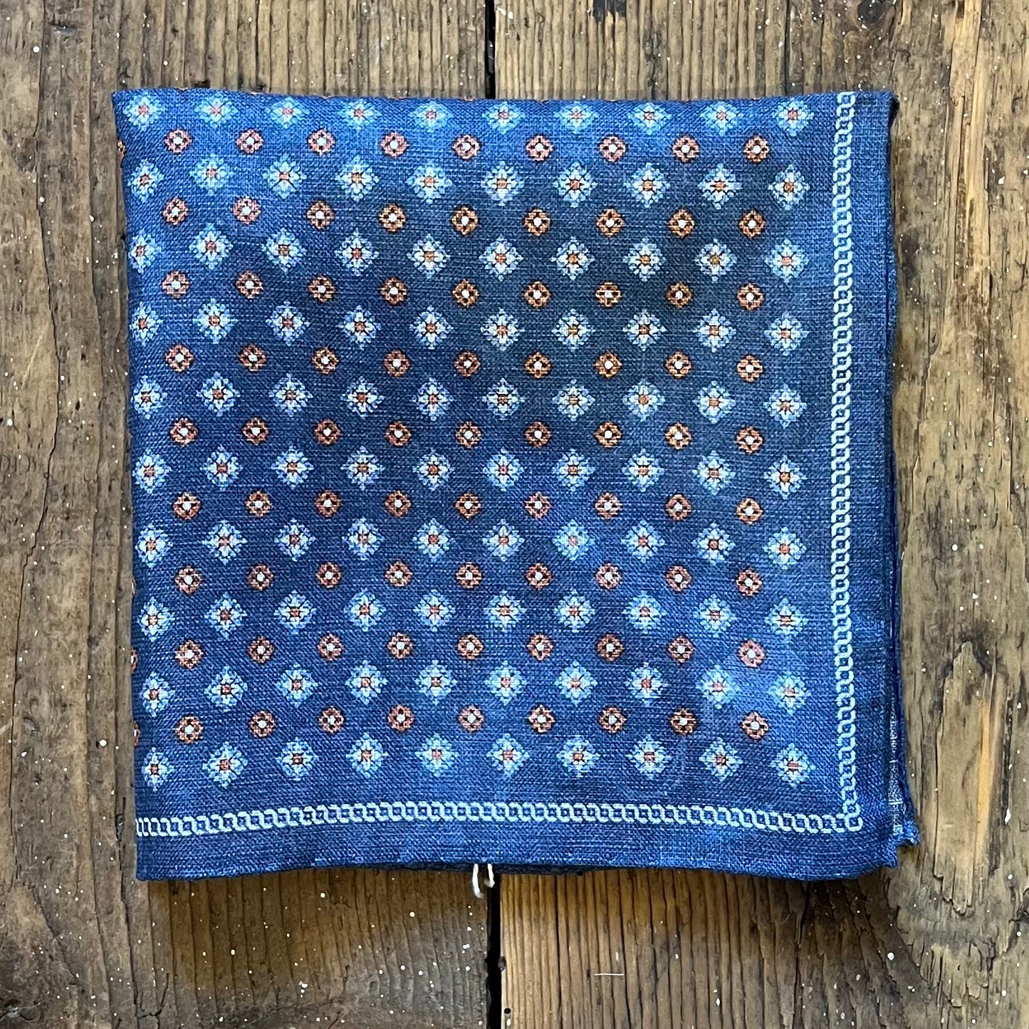 Linen pocket square with orange and light blue motif pattern