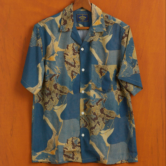 A bold blue tone print with reptile print camo. Short sleeve and Cuban collar with a patch pocket.