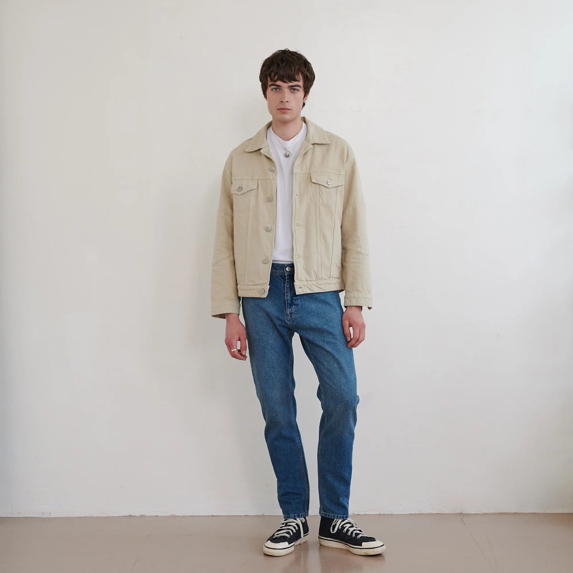 Stone 130oz cotton denim jacket with two front chest pockets and button fastenings.