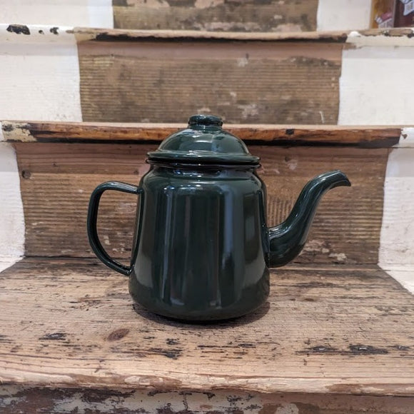 Small green traditional enamel teapot, curved handle removable lid.