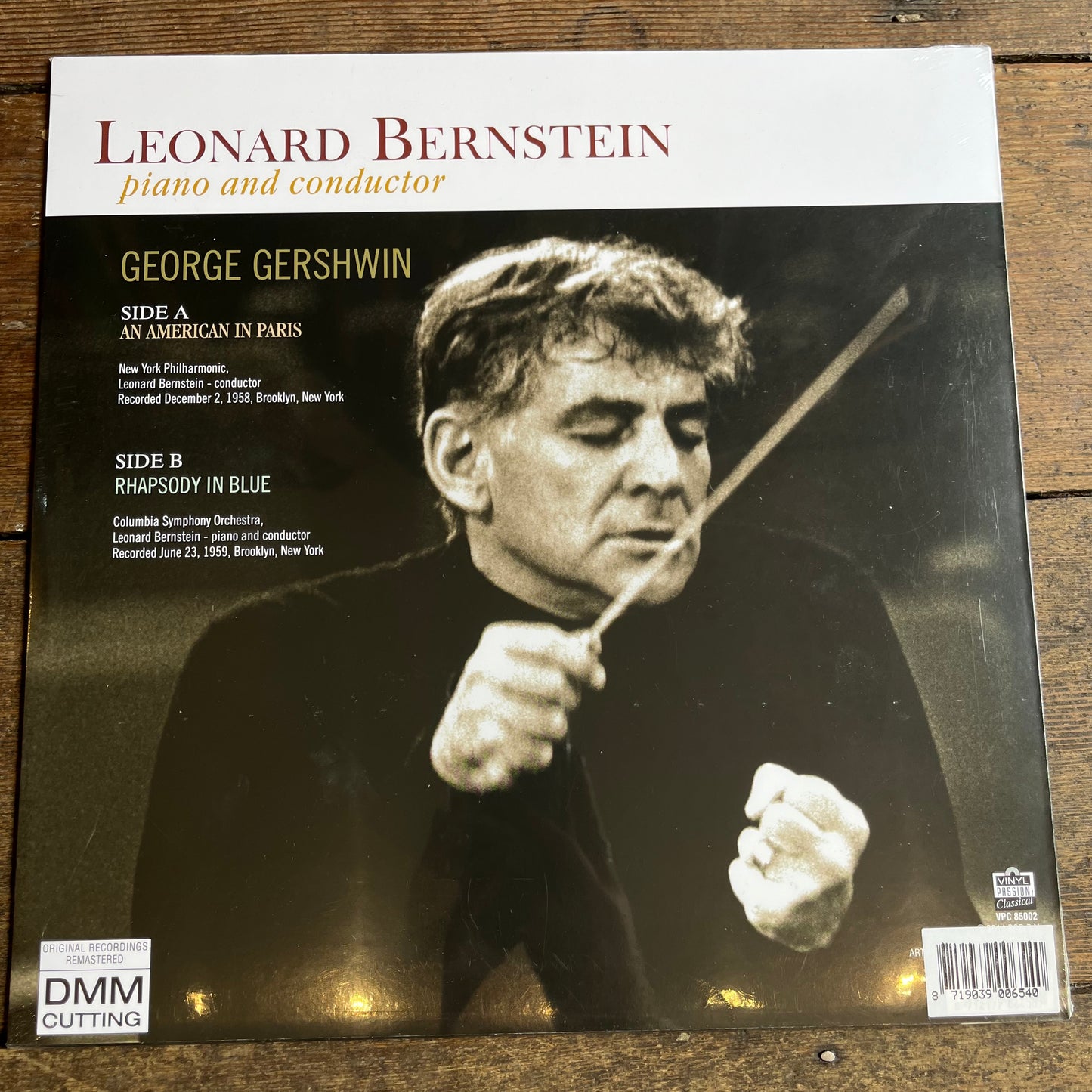 Vinyl record cover featuring Leonard Bernstein conducting with text about George Gershwin's music.