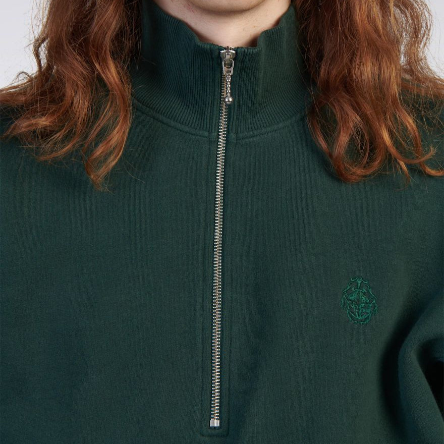 Green half-zip sweatshirt with a logo on a plain background