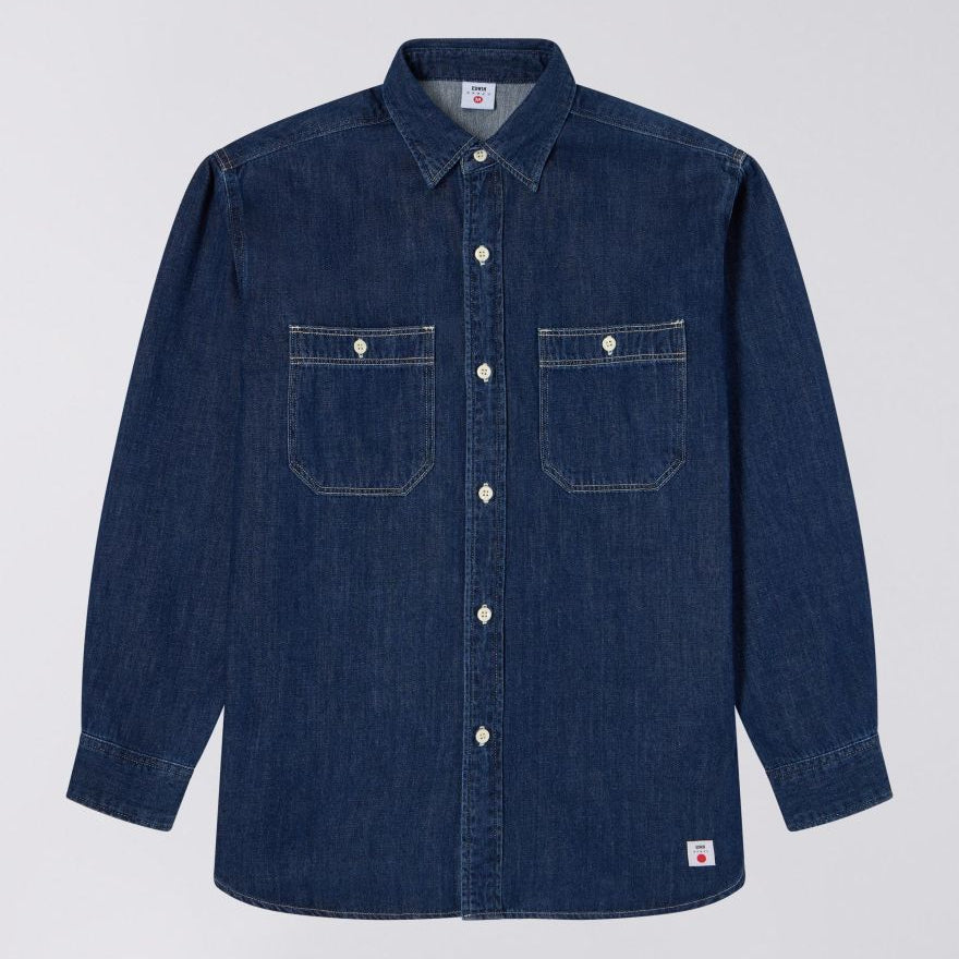Blue denim shirt with two front pockets on a light gray background