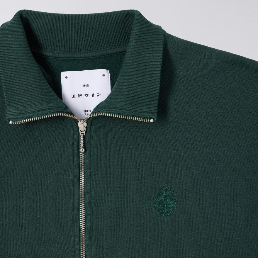 Green zip-up sweatshirt with collar and brand logo on a gray background