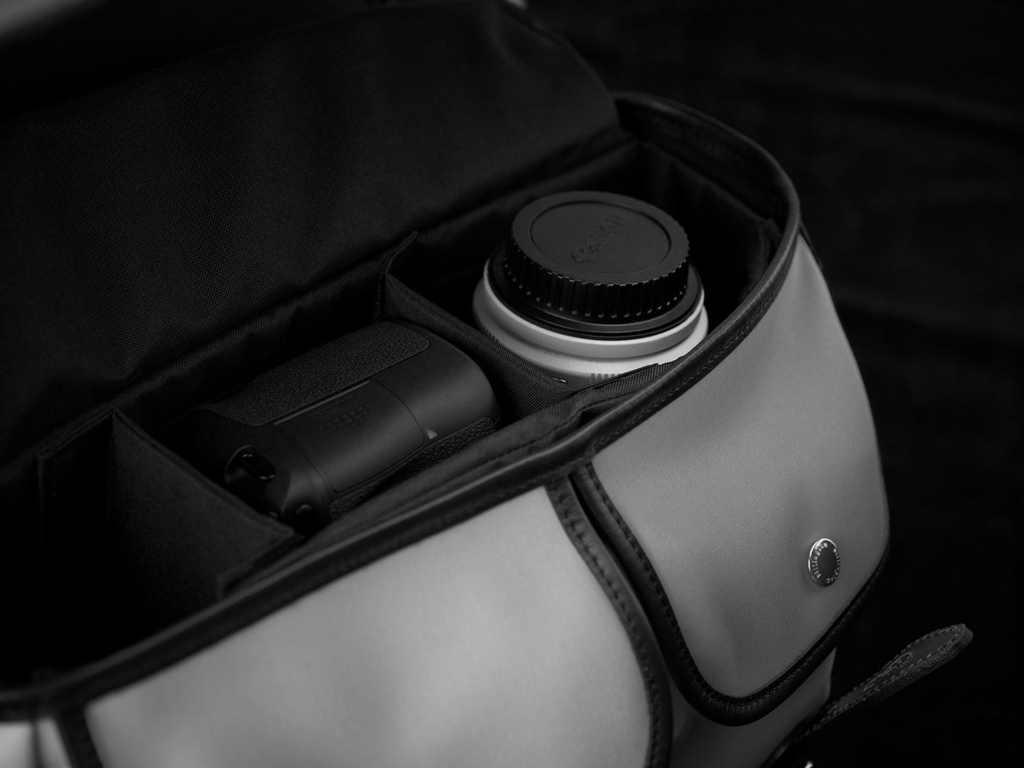 Travel, luggage and camera bag with removable padded insert for camera storage from Great British travelware experts Billingham, featuring waterproof composition, real grain leather, brass fittings and 5-year guarantee.