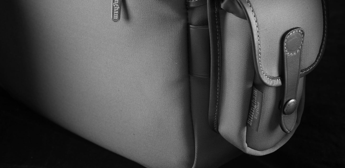 Travel, luggage and camera bag with removable padded insert for camera storage from Great British travelware experts Billingham, featuring waterproof composition, real grain leather, brass fittings and 5-year guarantee.