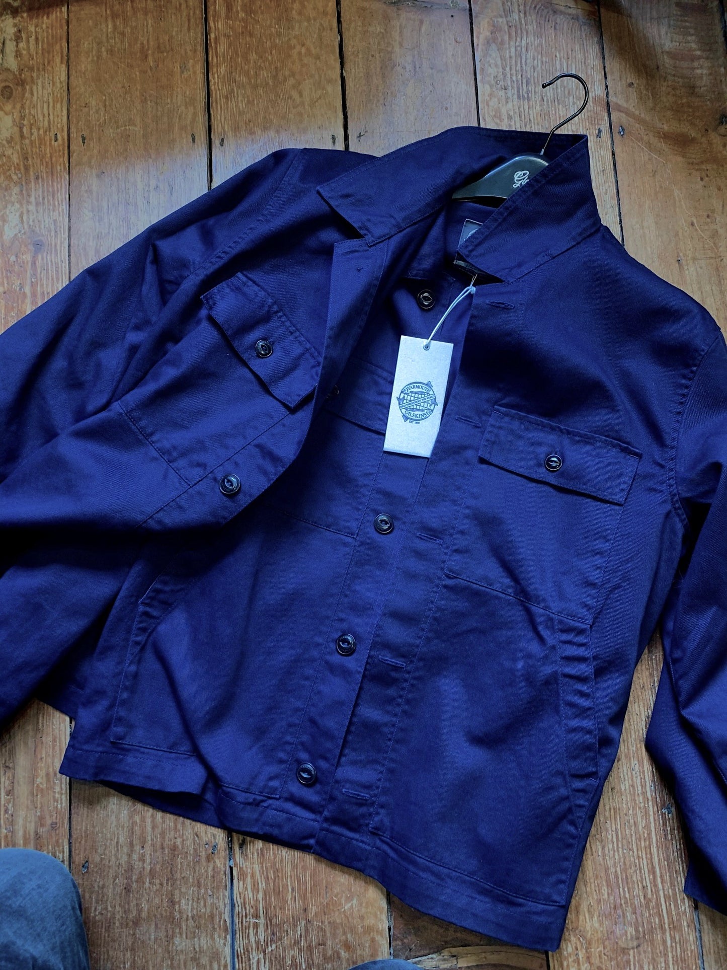 Navy workwear-style fisherman's jacket from independent UK brand Yarmouth Oilskins, featuring cotton composition, chest pockets and deep back yoke for ease of movement.