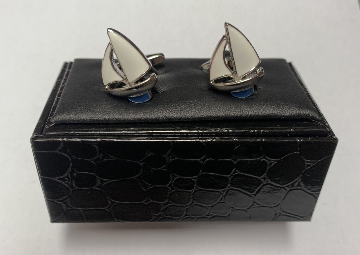 A pair of beautifully detailed cufflinks from Regent, shaped like two crisp white sailing yachts forging across the great ocean.