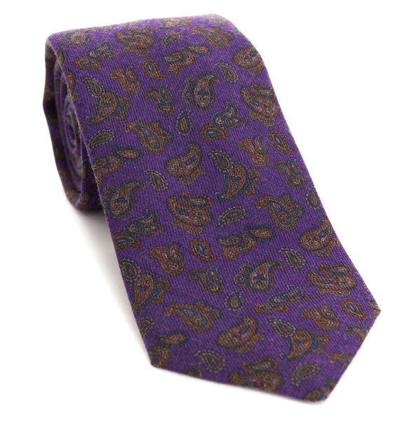 Luxury woven wool tie designed and made exclusively for Regent featuring a deep royal purple with autumnal red-brown and blue paisley leaves curling through the air of it.