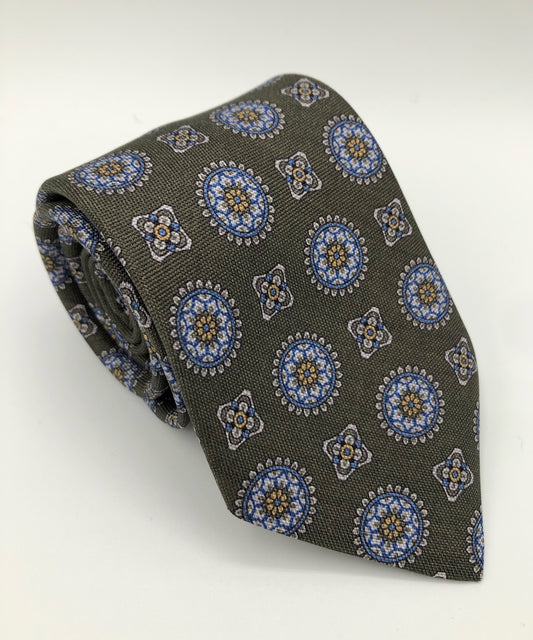 A luxury wool and silk tie designed by and handmade exclusively for Regent. A smart, Italianate olive is picked out by church-like stain-glass geometric shapes.