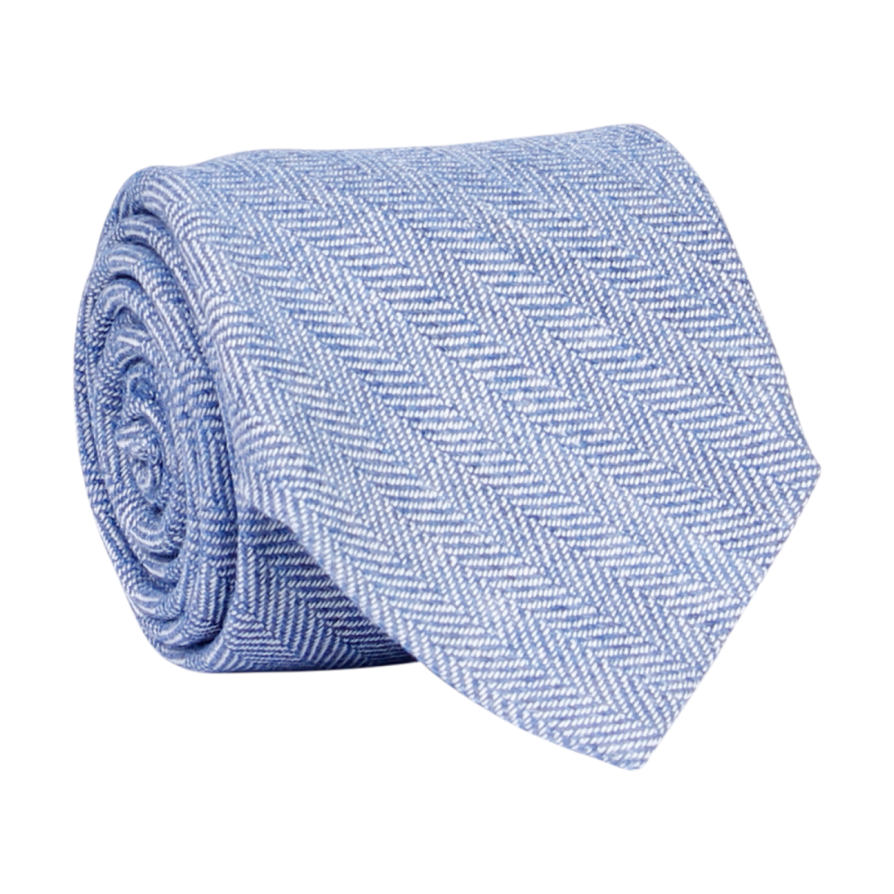 A luxury wool and silk tie designed by and handmade exclusively for Regent. Dazzling sky blue is picked out finely by fishbone diagonals, for a commanding, serene finish. Excellent for everyday and special occasions alike.