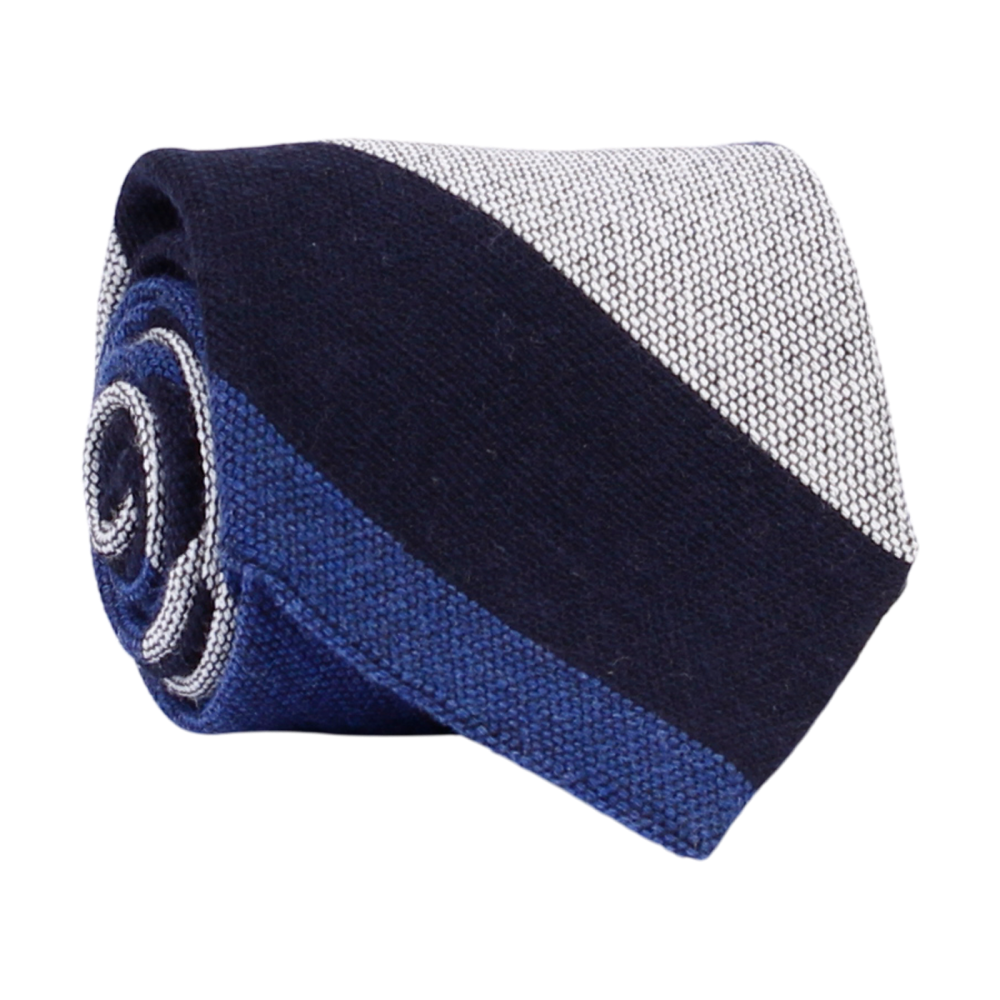 A luxury wool and silk tie designed by and handmade exclusively for Regent. Smart, serene navy and blue ride across sail-white for a calm, commanding finish. Excellent for everyday and special occasions alike.