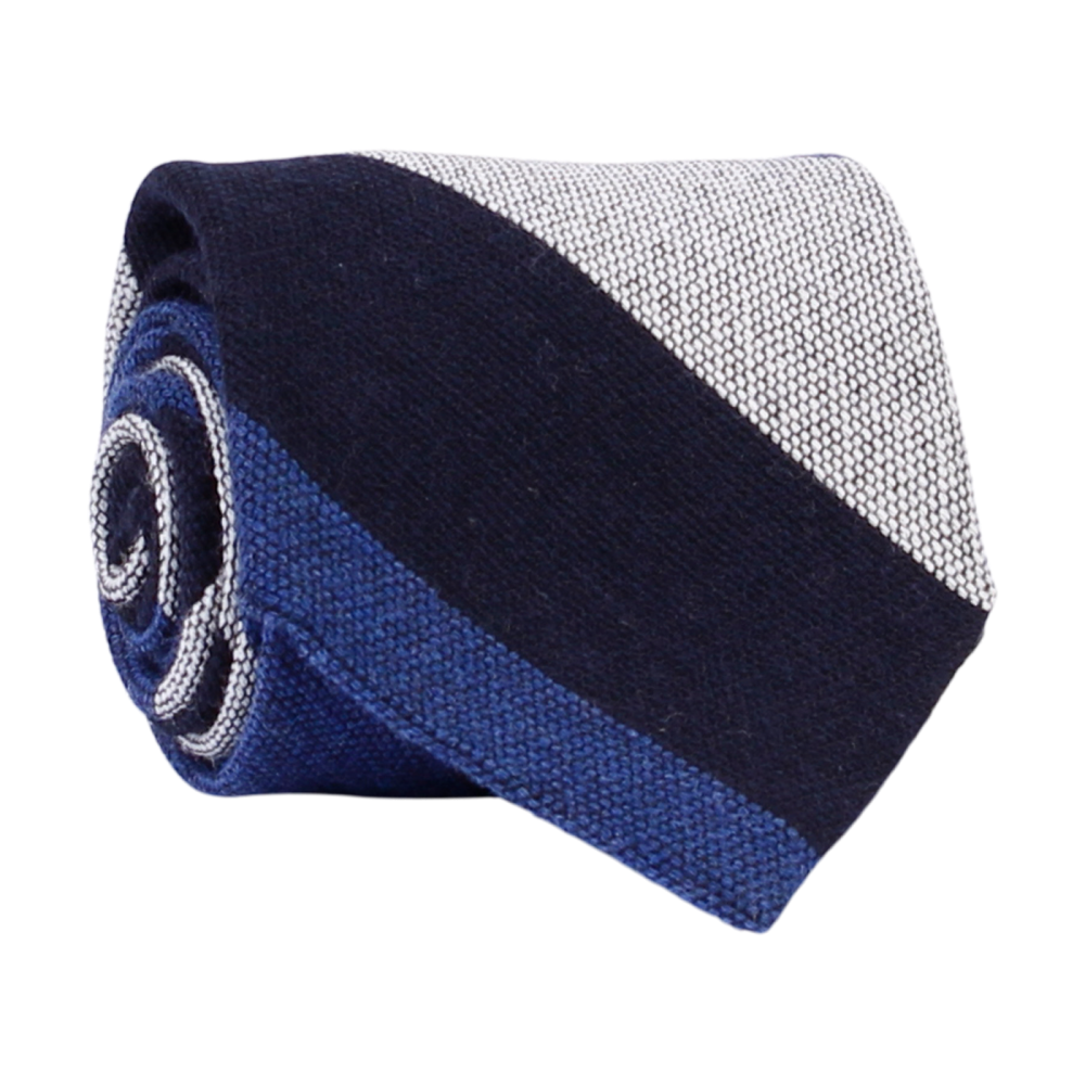 A luxury wool and silk tie designed by and handmade exclusively for Regent. Smart, serene navy and blue ride across sail-white for a calm, commanding finish. Excellent for everyday and special occasions alike. 
