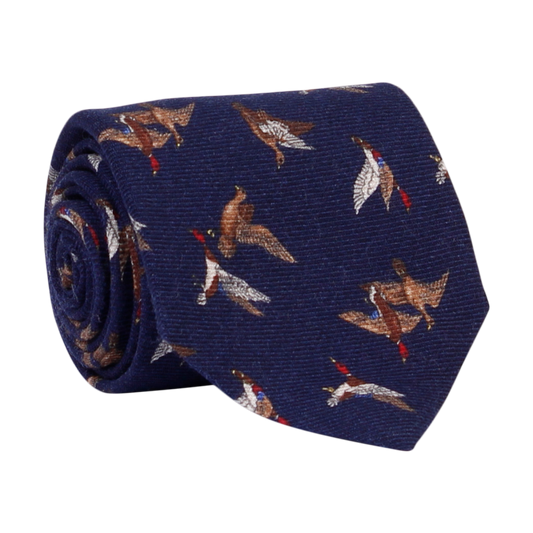 A luxury wool and silk tie designed by and handmade exclusively for Regent. A crisp peaceful wintery night navy is traversed by a flock of wild ducks.