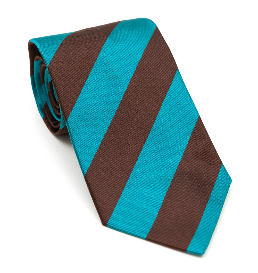 A luxury silk tie designed by and handmade exclusively for Regent. Spring sky blue combines with an earthen, chocolate brown for a rugged and charming finish.