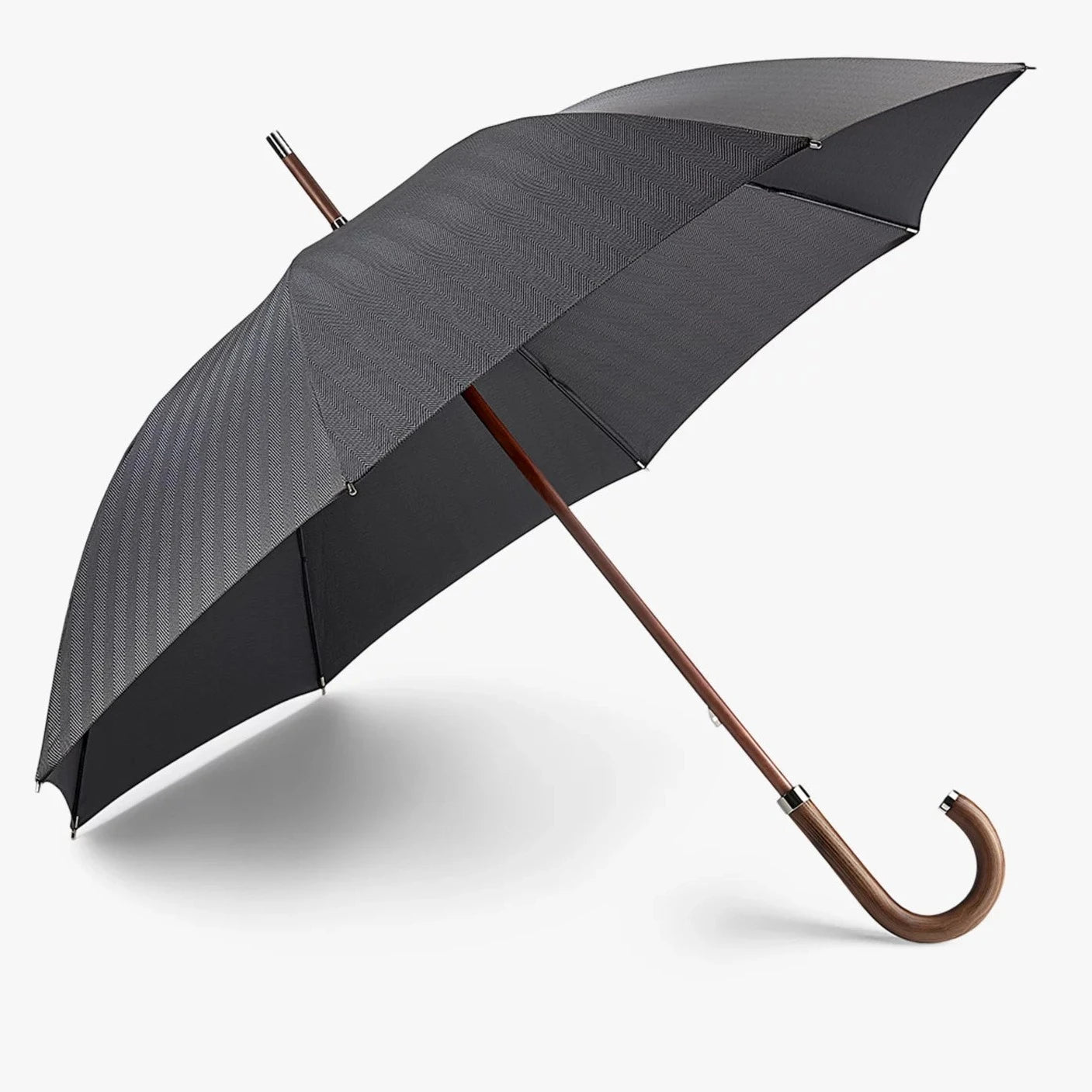 Fulton Radiant Herringbone Umbrella with wooden handle, shaft and ferrule leaning, open on a white background