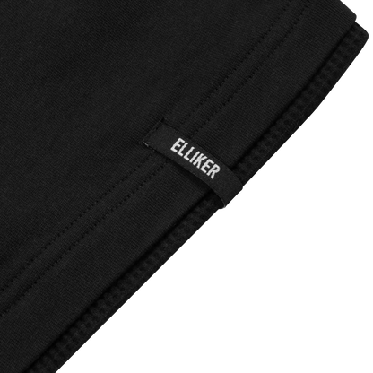 Close-up of a black knit fabric item folded over, showing a small black fabric tag with the brand name 'ELLIKER' in white text, against a white background.