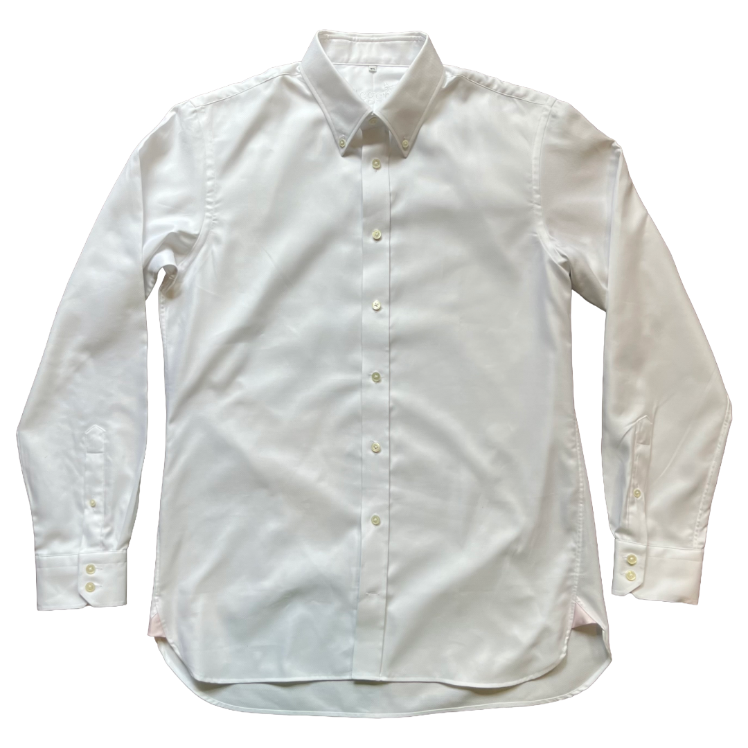 A white long-sleeve button-down dress shirt laid flat against a solid white background.