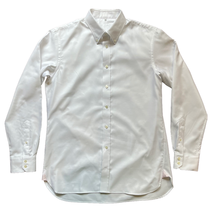 A white long-sleeve button-down dress shirt laid flat against a solid white background.