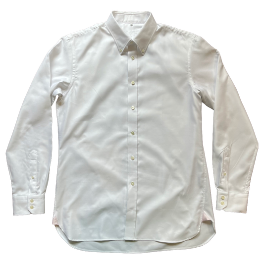 A white long-sleeve button-down dress shirt laid flat against a solid white background.