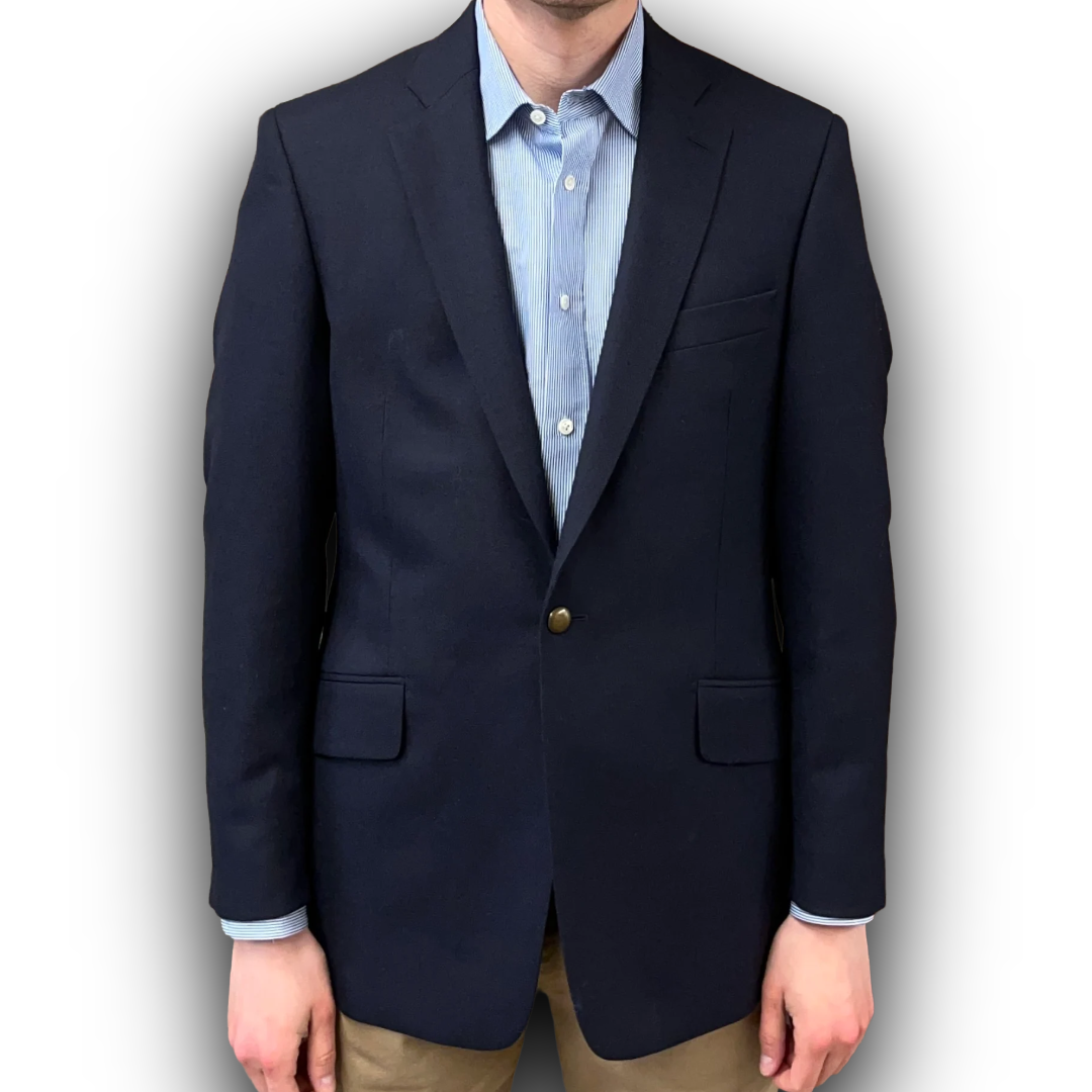 Navy blazer over a light blue shirt with a white background