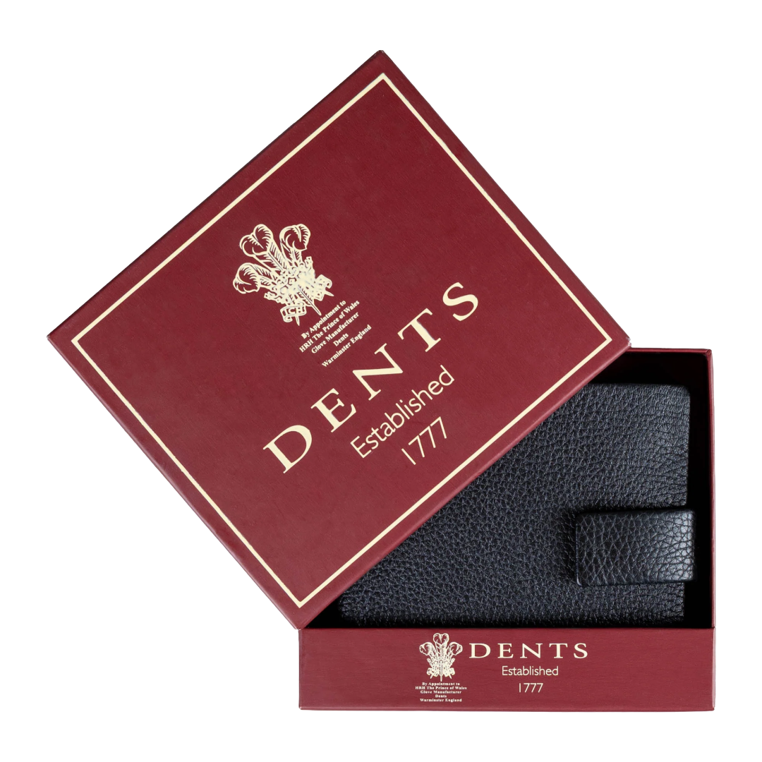 A black textured leather accessory, likely a wallet or pocket square, presented inside an open burgundy DENTS gift box with gold lettering on a white background.