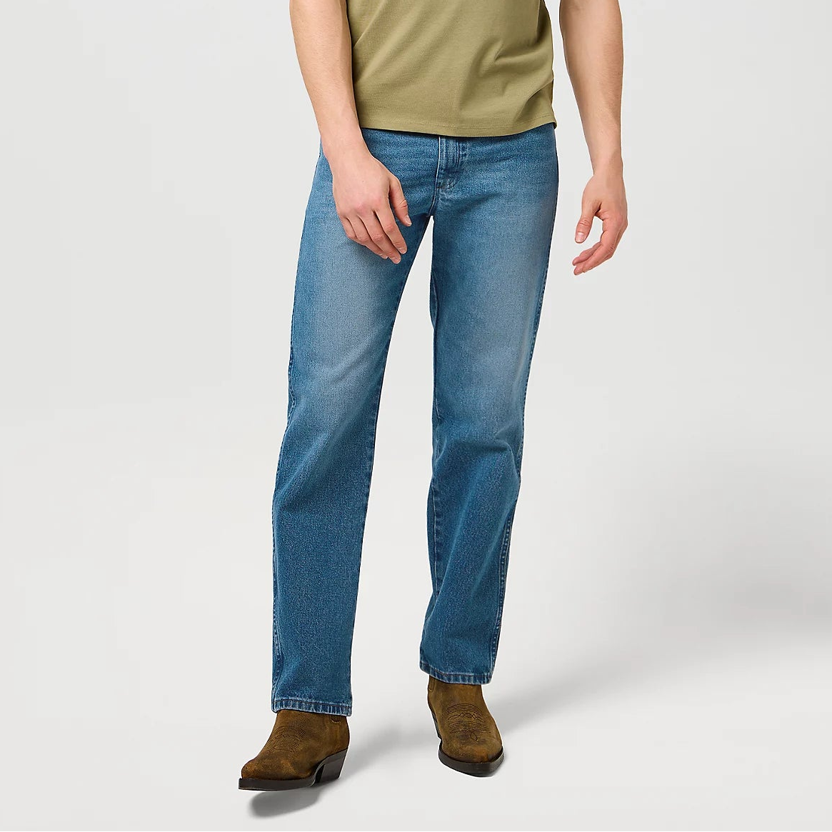 Man wearing a green t-shirt and blue jeans on a white background