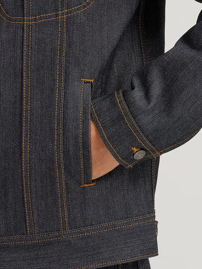 Close-up of a dark denim jacket with brown buttons and collar.