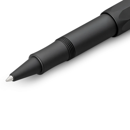 A close-up of a matte black ballpoint pen with a silver metal tip, shown diagonally on a clean white background.